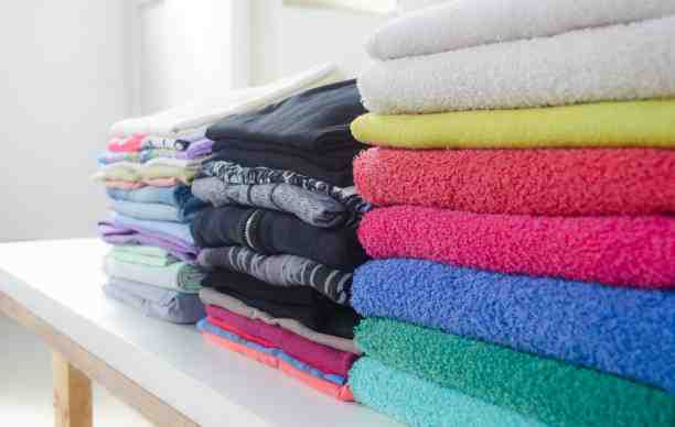 neatly folded laundry - fluff and fold cost